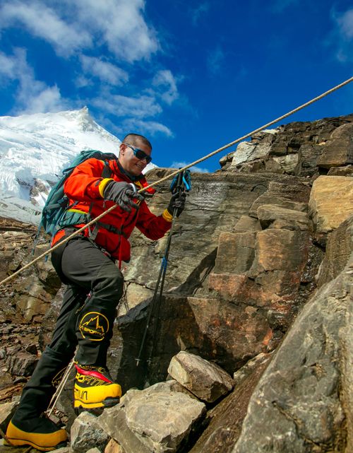 Udaya Gartaula climbing rocks